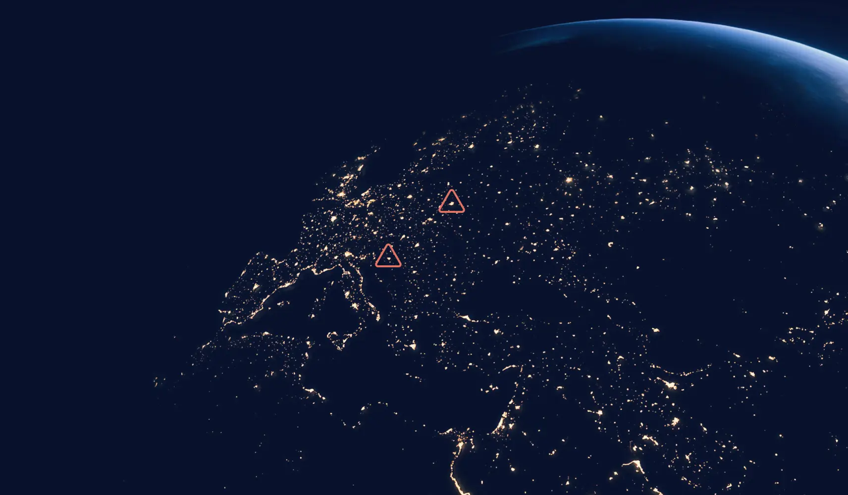 Earth at night showing illuminated Europe and surrounding regions from space.